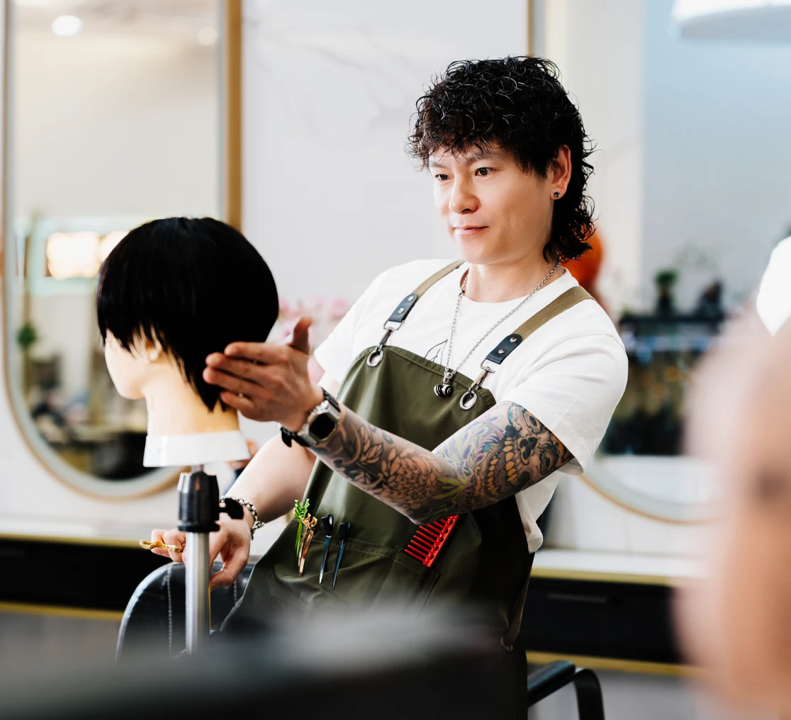 Stylist working on mannequin hairstyle